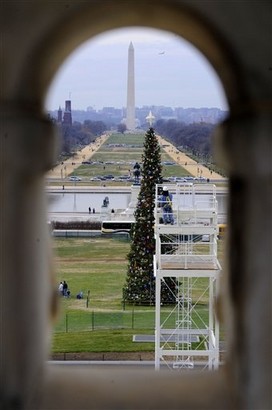 A worker paints the center stand of the inaugural platform, ...