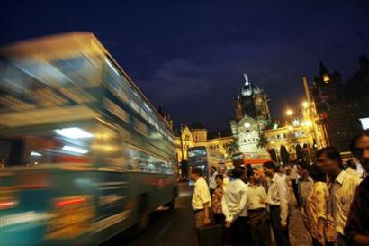 A double-decker bus goes past Chhatrapati Shivaji Terminus railway ...