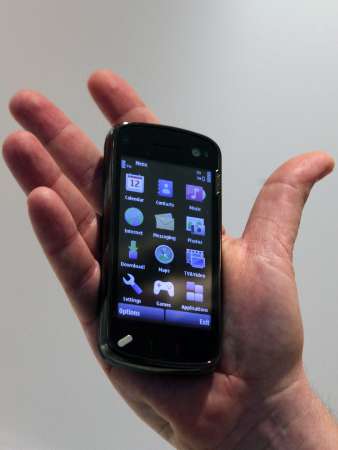 A Nokia N97 is demonstrated at the Nokia Capital Markets Day ...