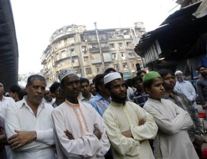 Indian Muslims attend a condolence meeting to remember the victims ...