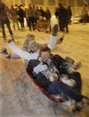 A group of women sled down a hill on Virginia Street as heavy ...