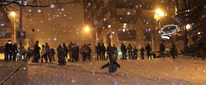 People gather at the top of a hill on Virginia Street as heavy ...