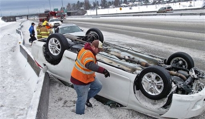 Tow truck driver Raymond Wilson prepares to right car that overturned ...