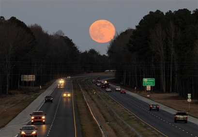 The full moon rises over  Fayetteville, N.C. on  Friday, Dec. ...