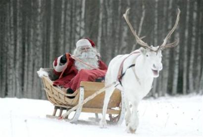 A man dressed as Santa Claus rides his sleigh in northern Finland, ...